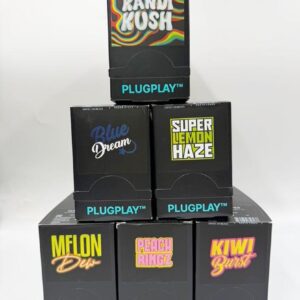 Stacked boxes of PLUGPLAY AIO 1g vape pods featuring DNA and Exotics strains like Kandi Kush and Blue Dream.